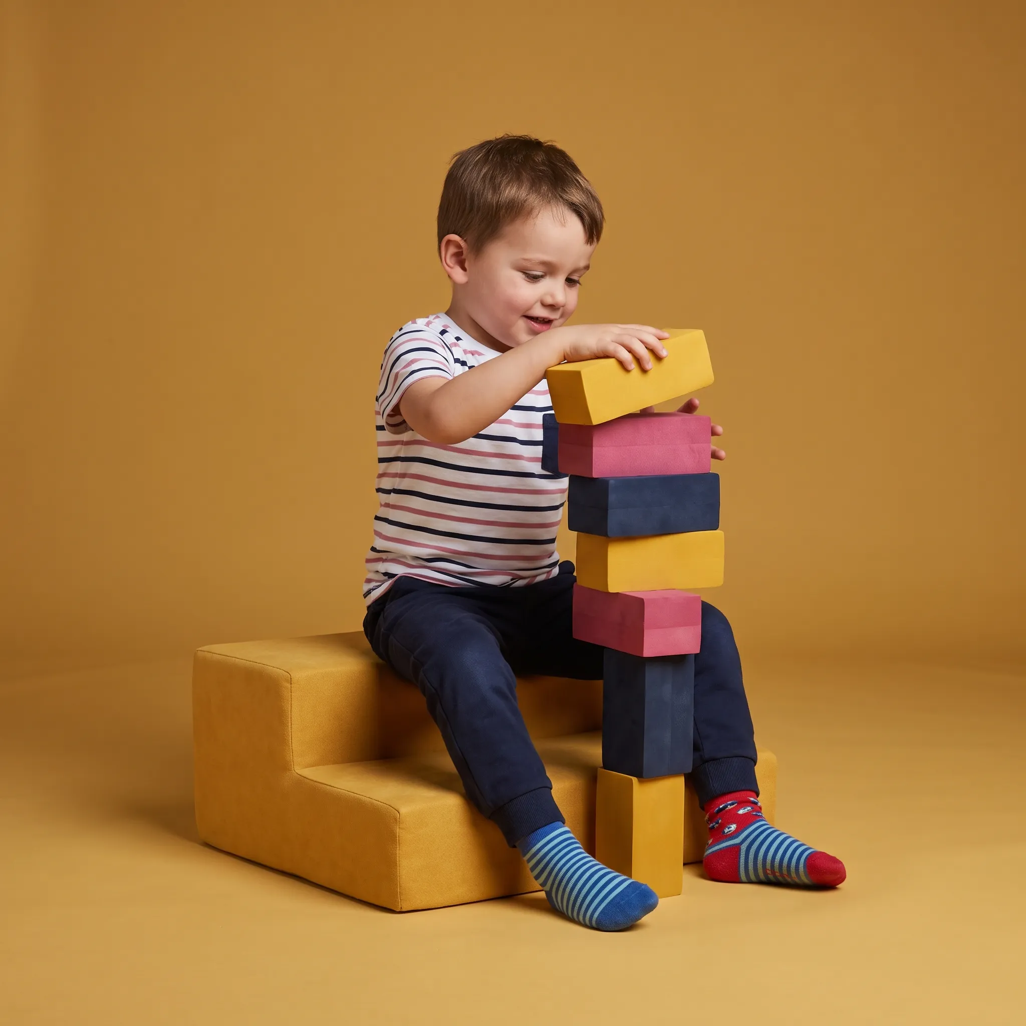A boy stacking colorful blocks